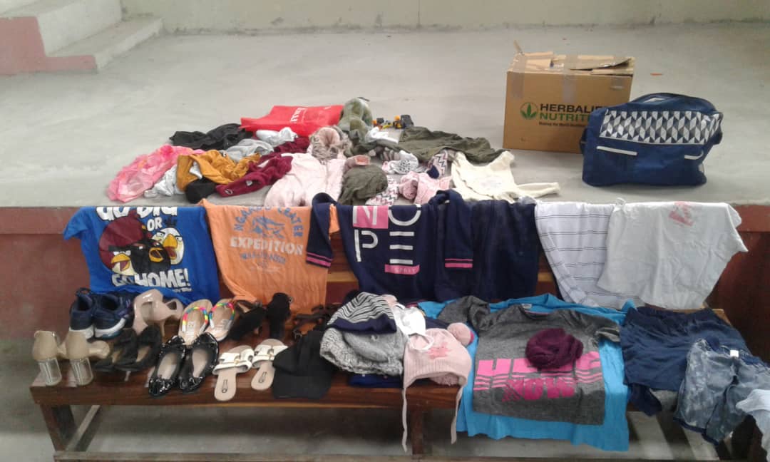 Donated clothes, shoes, and essentials prepared for vulnerable children and families.