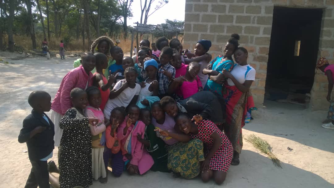 Children and caregivers gathered for a group photo at the community center.