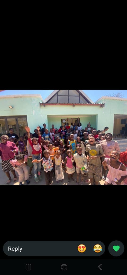 Children and community members celebrating together outside the MOVSC centre.